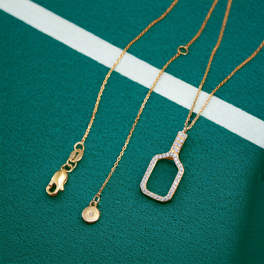 Fine Pickleball Belle Volley Necklace Solid 14k Gold with Diamonds. This stunning necklace features a diamond rimmed pickleball paddle with intricately set non-farmed diamonds for a stunning piece of jewelry!