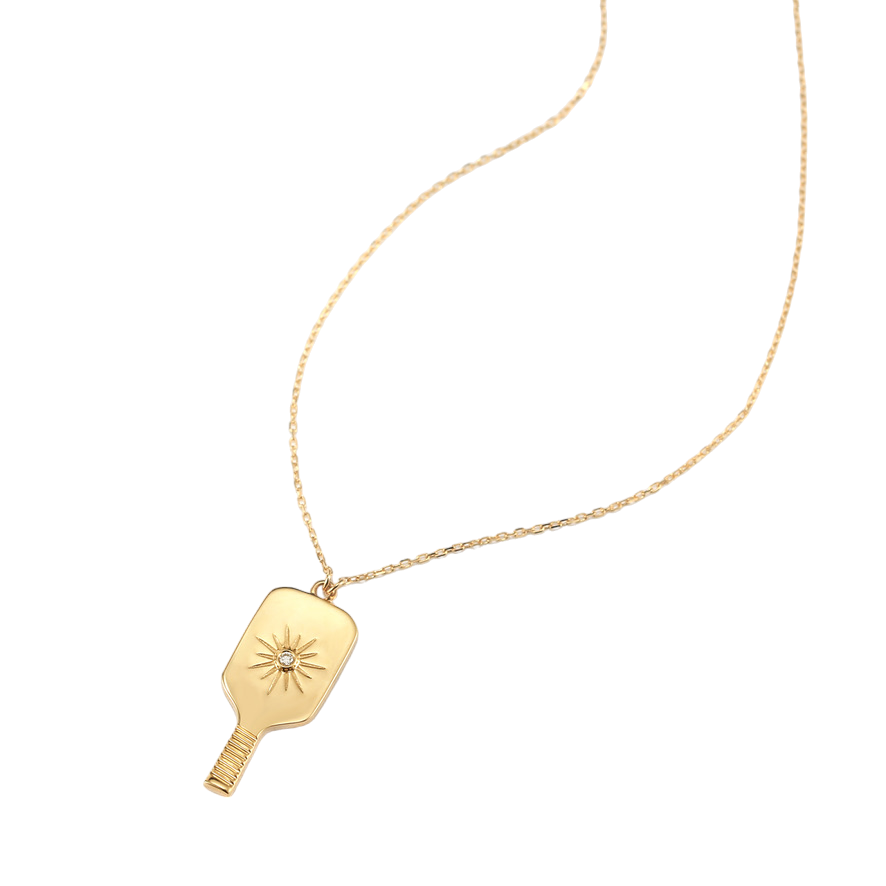 Fine Pickleball Paddle Pendant Necklace Solid 14k Gold with Diamond featuring a perfectly proportioned pickleball paddle with an impact center burst to imitate the instant the pickleball is hit. A pretty sparkling real non-farmed diamond marks the spot!