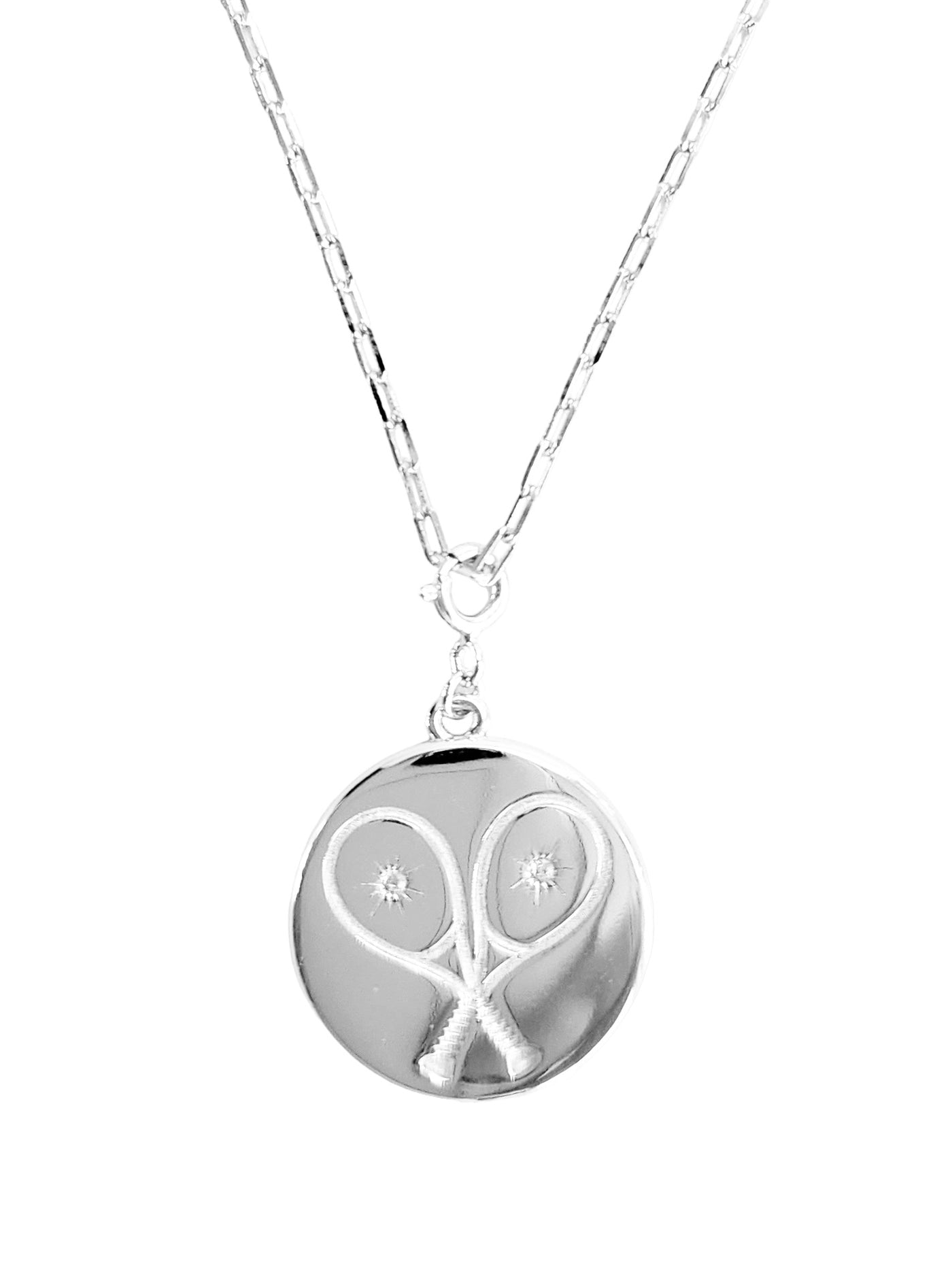 Chic Silver Tennis Heart Disc Necklace featuring  double sided pendant charm with 2 racquets creating a 'heart' with impact crystal inside each and our LoveMatch insignia on the reverse with a sparkling crystal center. Hangs from a chic, modern paper clip style chain - 16" with a 2" extender. 