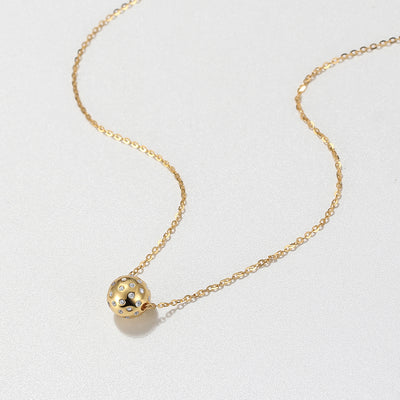 The Baby Belle with crystal accents 3D realistic Gold Pickleball Necklace. 3D small (8mm) pickleball in gold moves along our dainty gold chain and catches the sun with the added CZ crystals. Made from 18k gold over sustainably sourced sterling silver, this piece has a warm finish and whimsical style with a delicate but sturdy chain. We made this piece 18" with a 2" extender but you can shorten it up to 16" as well - so versatile!