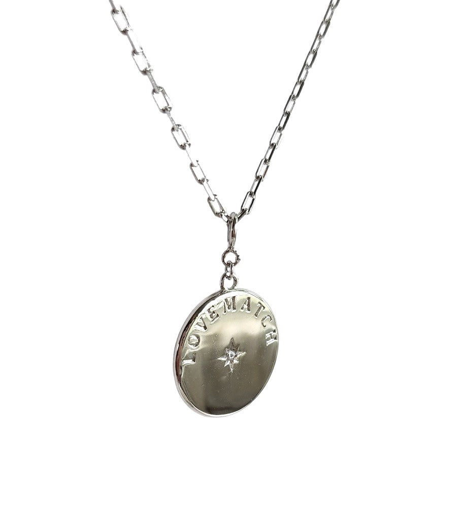 Chic Silver Tennis Heart Disc Necklace featuring  double sided pendant charm with 2 racquets creating a 'heart' with impact crystal inside each and our LoveMatch insignia on the reverse with a sparkling crystal center. Hangs from a chic, modern paper clip style chain - 16" with a 2" extender. 