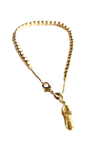 Dainty gold-filled bead ball bracelet with Exclusive LoveMatch tennis shoe charm hanging from it.