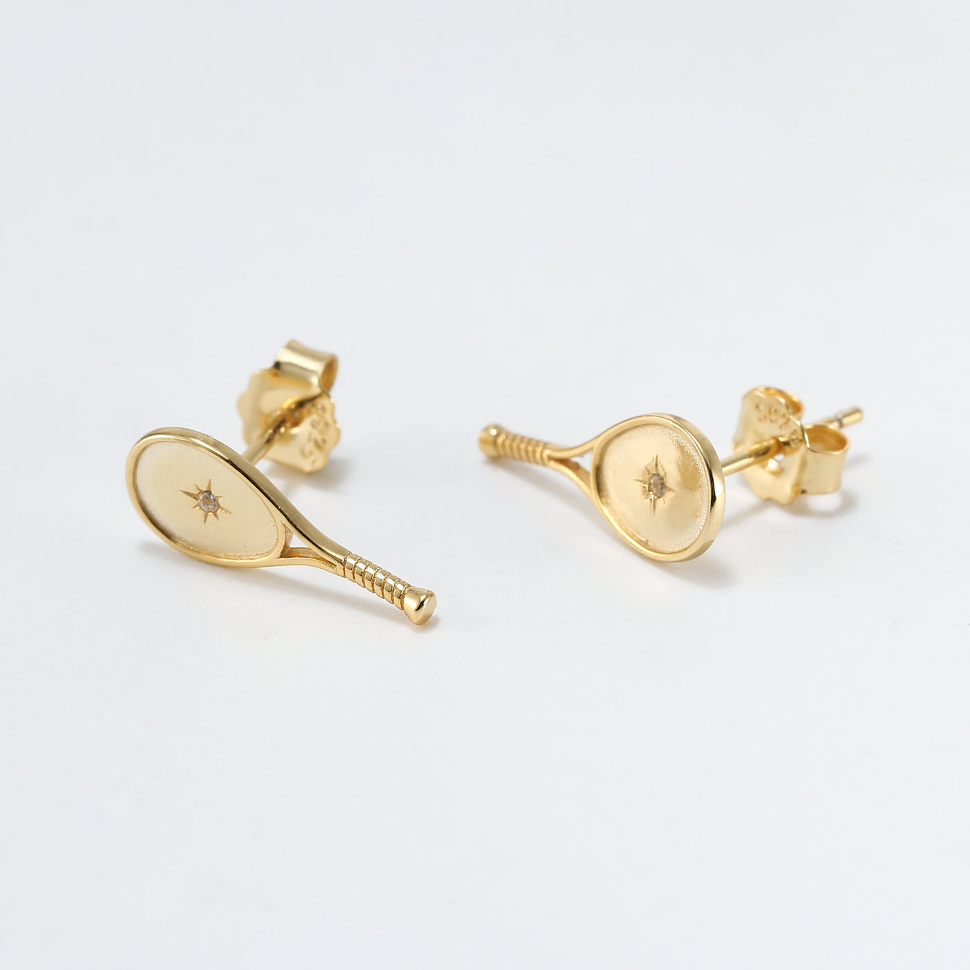 LoveMatch Gold Tennis Racquet Stud Earrings.  Featuring A classic racquet shape with a set crystal and impact starburst design. 15mm long.