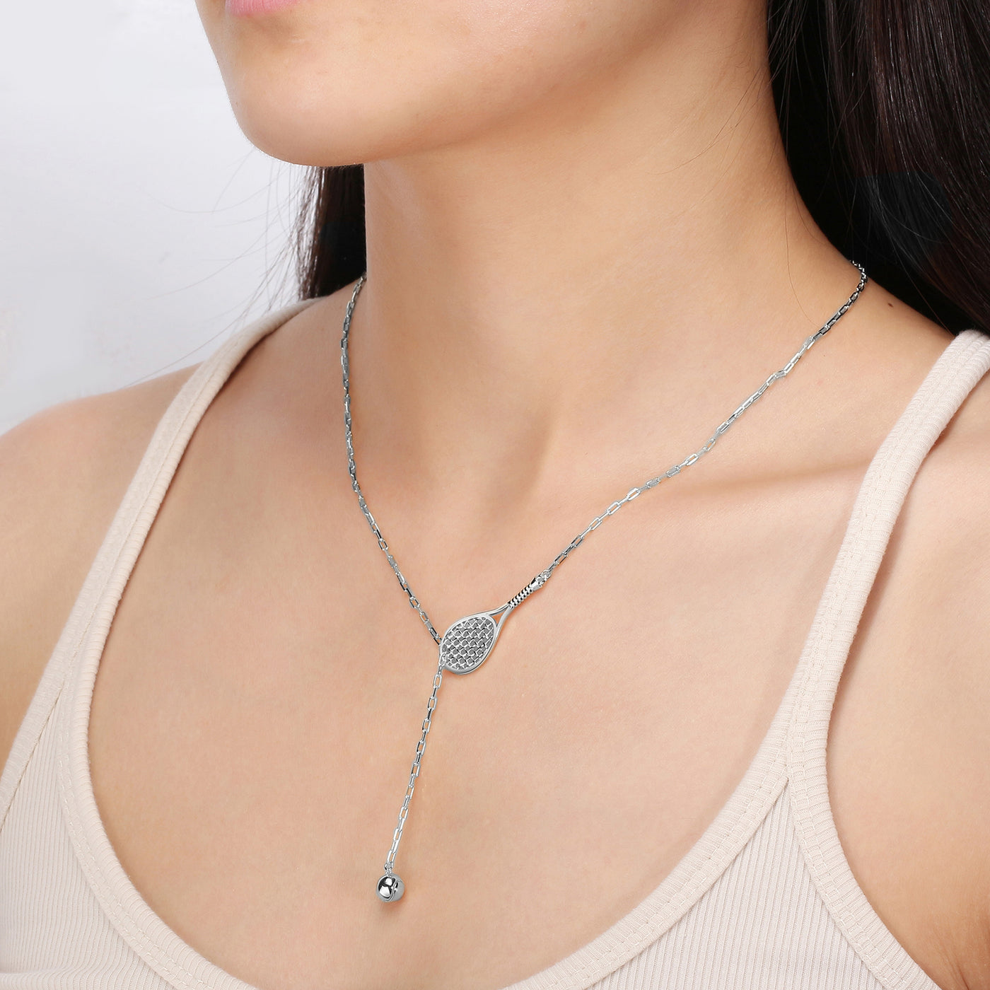 Lovematch Designs Silver Lariat Necklace featuring a tennis racquet with  tennis ball that feeds through racquet and hangs elegantly. Adjustable Chain Length.