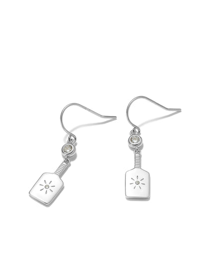 PickleBelle Paddle Drop Earrings in Sterling Silver. Features a dangling paddle below a sparkling crystal. Paddle even has a tiny stone and burst in the center reminiscent of a good hit on that sweet spot! These earrings dangle and are Sterling Silver with a protective rhodium plating.