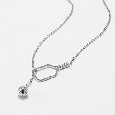 Pickleball Lariat PLUS Silver Paddle and Ball Necklace. Adorned with sparkling crystals and crafted from sterling silver with a rhodium plating, this necklace boasts exquisite detail and adjusts from 17" to nearly 20".