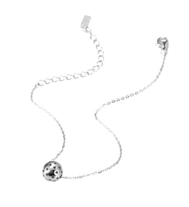 Charming Silver Baby Belle Pickleball Bracelet with Single Pickleball. This bracelet is made from sustainably sourced sterling silver. Visually accurate micro pickleball in silver, moves along our dainty 6.5" gold chain with a 2" extender.