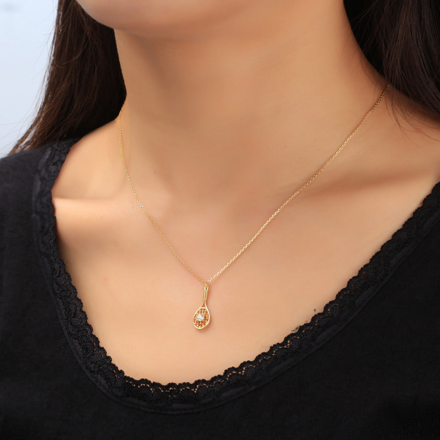 Crystal Ball and Gold Tennis Racquet Pendant Necklace.