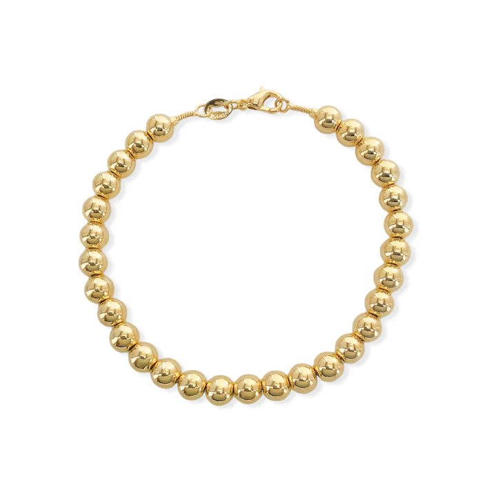 Gold-filled bead ball bracelet. 7.25" with a lobster clasp, 4mm diameter beads and comes with branded microsuede pouch. Wear as is or add in any of our themed charms for added wow factor.