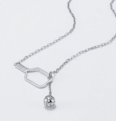 Pickleball Lariat Silver Paddle and Ball Necklace. Our select clip link chain weaves through an open pickleball paddle, with a chic pickleball as a gorgeous counterweight for a splash of style and fun.&nbsp;  The necklace adjusts from 17" to 19.5".