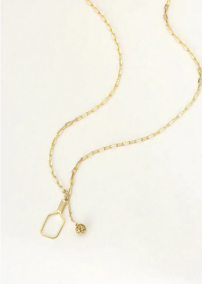 Pickleball The Mini Volley Necklace Gold. A delicate but perfect 18mm paddle pendant with a swinging pickleball charm suspends off of a dainty clip chain. This can be worn as a choker at 15” and can extend to 17”.Made from sustainably sourced Sterling Silver with a thick 14k &amp; gold overlay, comes on a delicate but sturdy clip chain that adds a touch of contemporary style.